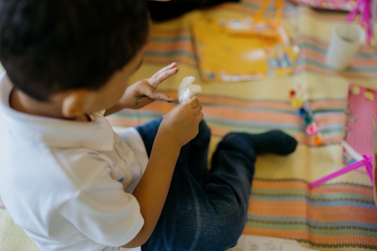 A child happily making art and crafts in the Philippines
