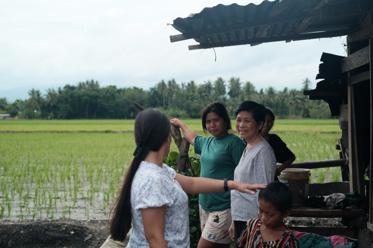 Families beside their rice fields in Mindanao, Philippines