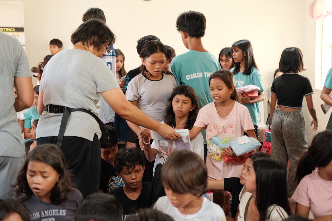 Children smiling as they receive care at a community outreach in Mindanao