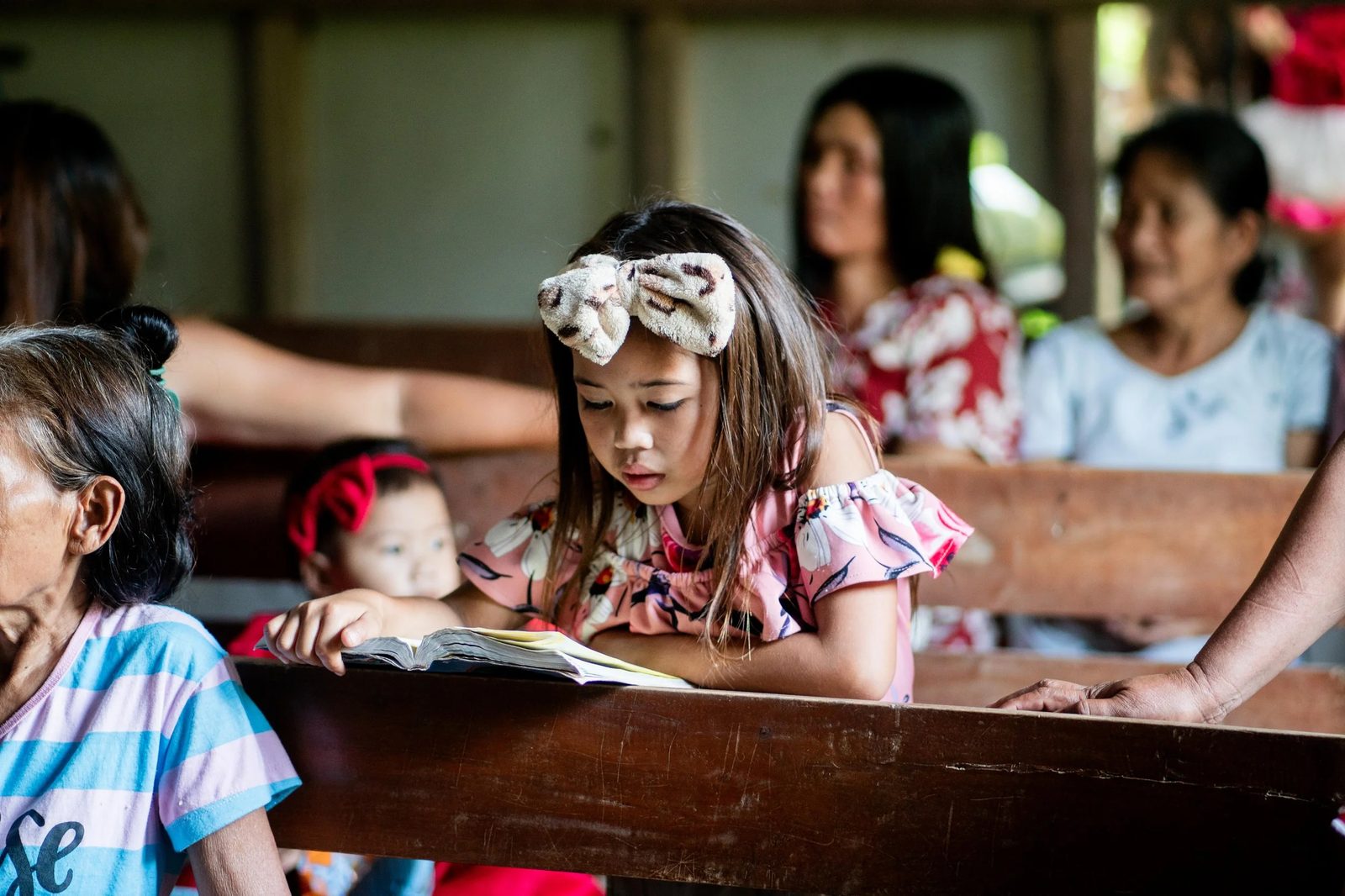 A young Filipino girl reading a book